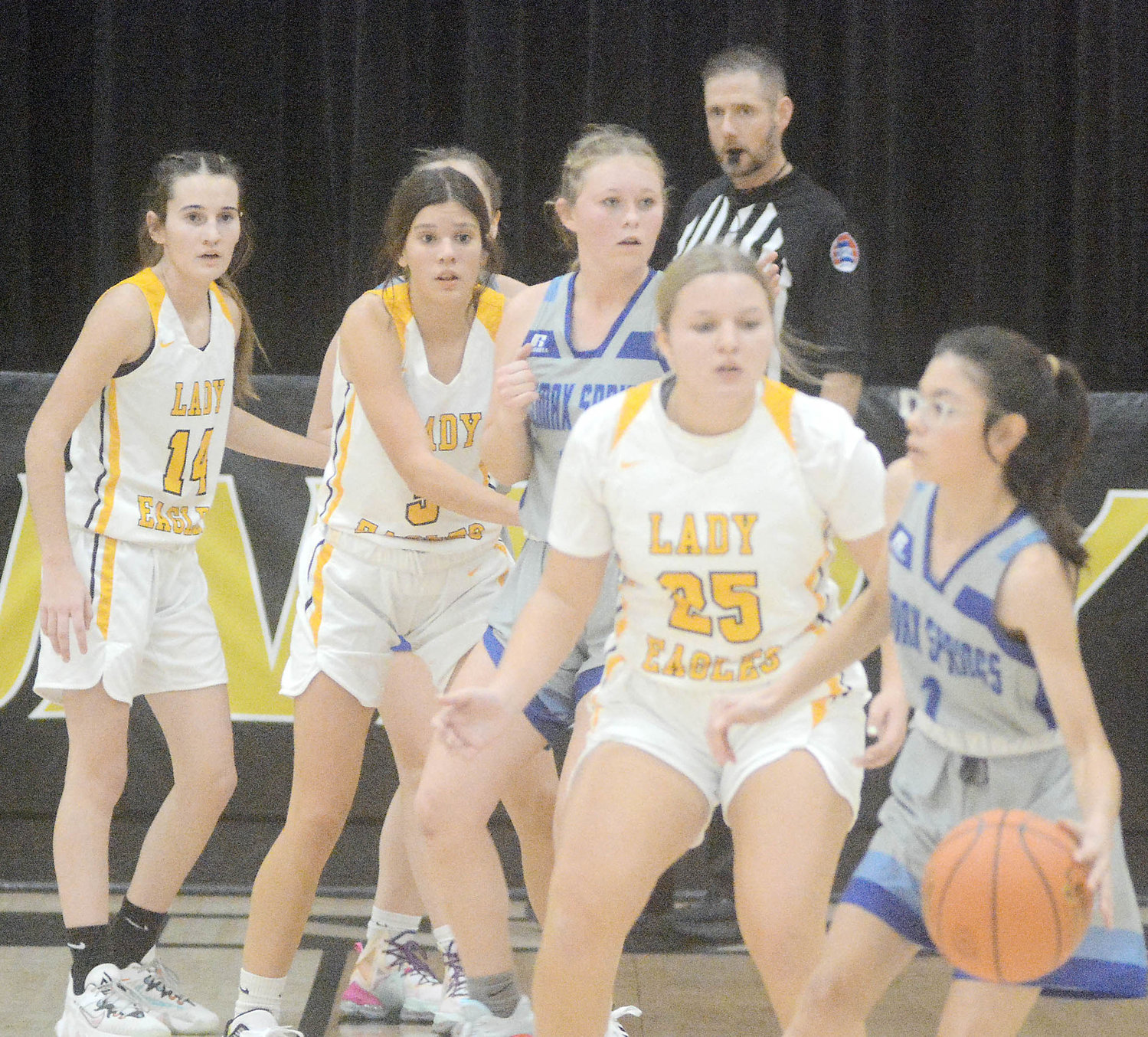 Lady Eagle defenders (from left) Brooke Mercer, Aubrey Reeves and Marissa Hollis keep an eye on the basketball in the hands of Climax Springs’ Lizette Rivera.